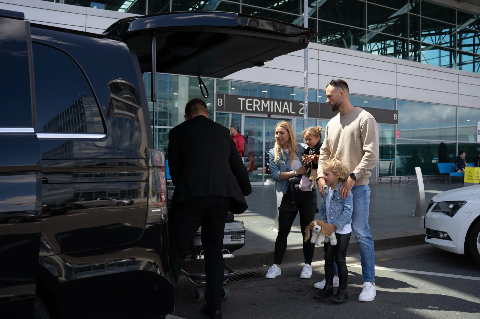 Driver loading luggage at Prague Airport
